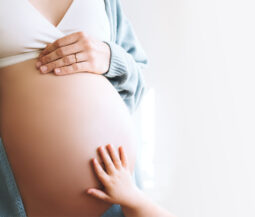 pregnant with kids hand on her stomach
